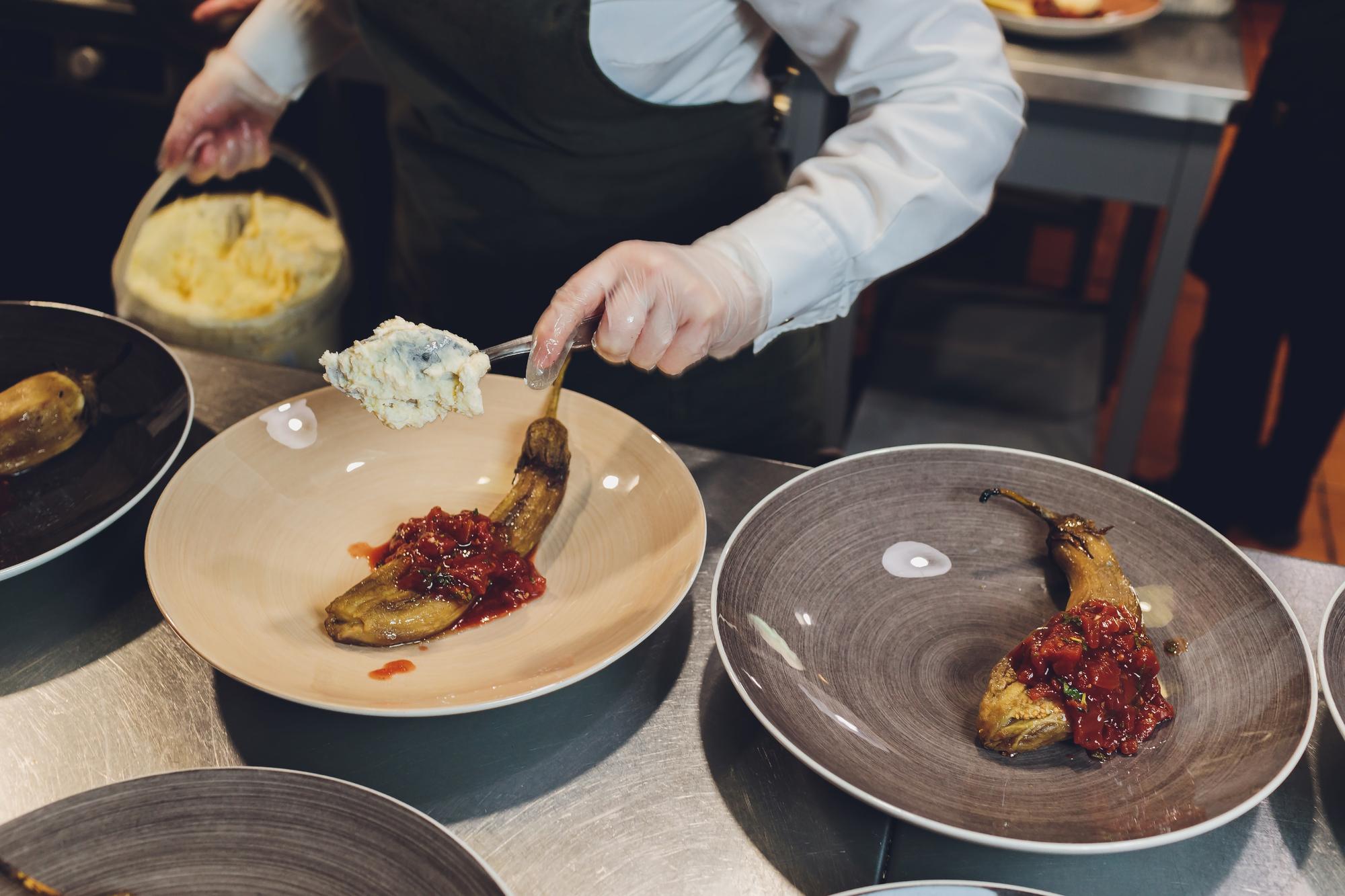 Instructor plating a composed dish